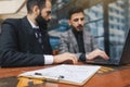 business people meets outdoors. Two men are using a laptop. Working break. Team and business support. Collaboration and Royalty Free Stock Photo