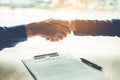 Business people negotiating a contract handshake between two col Royalty Free Stock Photo