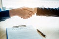 Business people negotiating a contract handshake between two col Royalty Free Stock Photo