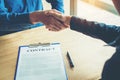 Business people negotiating a contract handshake between two col Royalty Free Stock Photo