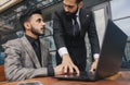 Business people outdoor meeting. A group of business people meet outdoors. Two men are using a laptop. Working break Royalty Free Stock Photo