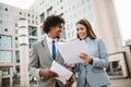 Handsome african businessman man and his beautiful female colleague talking to each other outside the Royalty Free Stock Photo