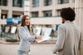 Handsome african businessman man and his beautiful female colleague talking to each other outside the Royalty Free Stock Photo