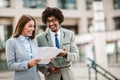 Handsome african businessman man and his beautiful female colleague talking to each other outside the Royalty Free Stock Photo