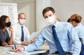 Businessman wearing face protective mask at office