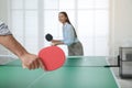 Business people playing ping pong in office, focus on racket Royalty Free Stock Photo