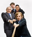 Business people playing tug-of-war Royalty Free Stock Photo