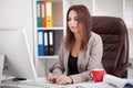 Business People. Portrait Of Woman In Office. Beautiful Confident Smiling Female Worker In Black Top and Gray Suit Sitting In Royalty Free Stock Photo