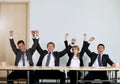 Business people punching air in office, cheering Royalty Free Stock Photo