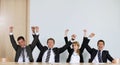 Business people punching air in office, cheering Royalty Free Stock Photo