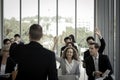 Business people raising hand up to ask question with speaker in seminar conference raise hands up to agree or vote for comments