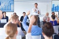 Business people raising their hands in business seminar Royalty Free Stock Photo