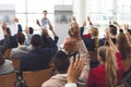 Business people raising their hands at a business seminar Royalty Free Stock Photo