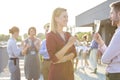 Business colleagues talking during success party at rooftop terrace Royalty Free Stock Photo