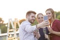 Smiling business colleagues talking during success party on rooftop Royalty Free Stock Photo