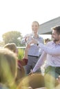 Smiling mature colleagues talking while standing at rooftop during success party Royalty Free Stock Photo