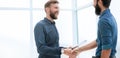 Business people shaking hands in a bright office Royalty Free Stock Photo