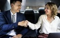 Business people shaking hands in car Royalty Free Stock Photo
