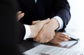 Business people shaking hands after contract signing in modern office. Teamwork, partnership and handshake concept Royalty Free Stock Photo