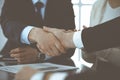 Business people shaking hands after contract signing in modern office. Teamwork, partnership and handshake concept Royalty Free Stock Photo