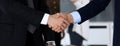 Business people shaking hands after contract signing in modern office. Unknown businessman, male entrepreneur with Royalty Free Stock Photo