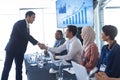 Business people shaking hands with each other while checking in business seminar Royalty Free Stock Photo