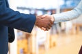 Business people shaking hands with each other in corridor at office Royalty Free Stock Photo