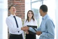Business people shaking hands with each other in the office. Royalty Free Stock Photo