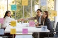 Business people shaking hands finishing a meeting for a new project. Group of Asian workers colleague dressed formally sitting Royalty Free Stock Photo