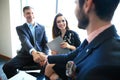 Business people shaking hands, finishing up a meeting.