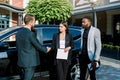 Business people shaking hands, finishing up a meeting. Caucasian man and woman shaking hands, African man coworker Royalty Free Stock Photo