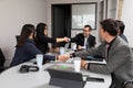 Business people shaking hands, finishing up a meeting, establishing multi-ethnic partnership, making deal in a meeting, Royalty Free Stock Photo