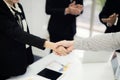 Business people shaking hands, finishing up a meeting to seal a