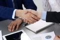 Business people shaking hands, finishing up a papers signing. Meeting, agreement and lawyer consulting concept Royalty Free Stock Photo