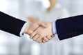 Business people shaking hands at meeting or negotiation, close-up. Group of unknown businessmen and a woman standing in Royalty Free Stock Photo