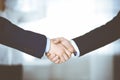 Business people shaking hands at meeting or negotiation, close-up. Group of unknown businessmen and a woman standing in Royalty Free Stock Photo