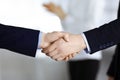 Business people shaking hands at meeting or negotiation, close-up. Group of unknown businessmen and a woman standing in Royalty Free Stock Photo