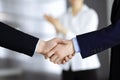 Business people shaking hands at meeting or negotiation, close-up. Group of unknown businessmen and a woman standing in Royalty Free Stock Photo
