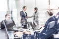 Business people shaking hands in moder corporate office. Royalty Free Stock Photo