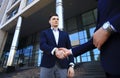 Business people shaking hands outside modern office building. Royalty Free Stock Photo