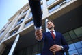 Business people shaking hands outside modern office building. Royalty Free Stock Photo