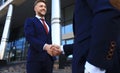 Business people shaking hands outside modern office building. Royalty Free Stock Photo