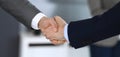 Business people shaking hands while standing with colleagues after meeting or negotiation, close-up. Group of unknown Royalty Free Stock Photo