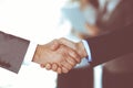 Business people shaking hands while standing with colleagues after meeting or negotiation, close-up. Group of unknown Royalty Free Stock Photo