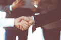 Business people shaking hands while standing with colleagues after meeting or negotiation, close-up. Group of unknown Royalty Free Stock Photo