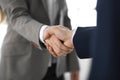 Business people shaking hands while standing with colleagues after meeting or negotiation, close-up. Group of unknown Royalty Free Stock Photo