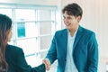 Business people shaking hands. Welcome to team. Young modern man and woman in smart casual wear shaking hands. Royalty Free Stock Photo