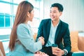 Business people shaking hands. Young modern man and woman in smart casual wear shaking hands . Royalty Free Stock Photo