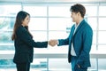 Business people shaking hands. Young modern man and women in smart casual wear shaking hands. Royalty Free Stock Photo