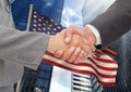 Business people shaking their hands against american flag and skyscraper Royalty Free Stock Photo